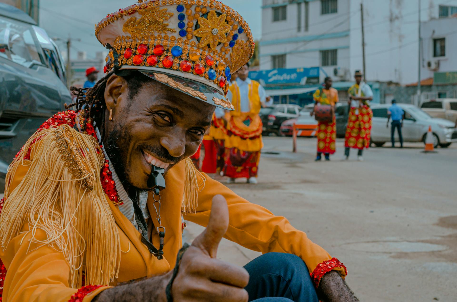 Performers in vibrant traditional costumes during a Luanda street carnival in Angola