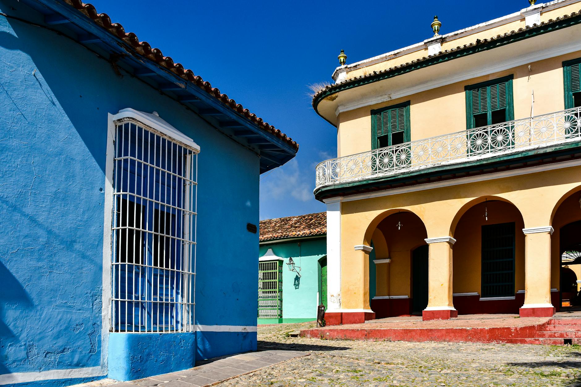 Colorful Caribbean colonial buildings along a tropical street