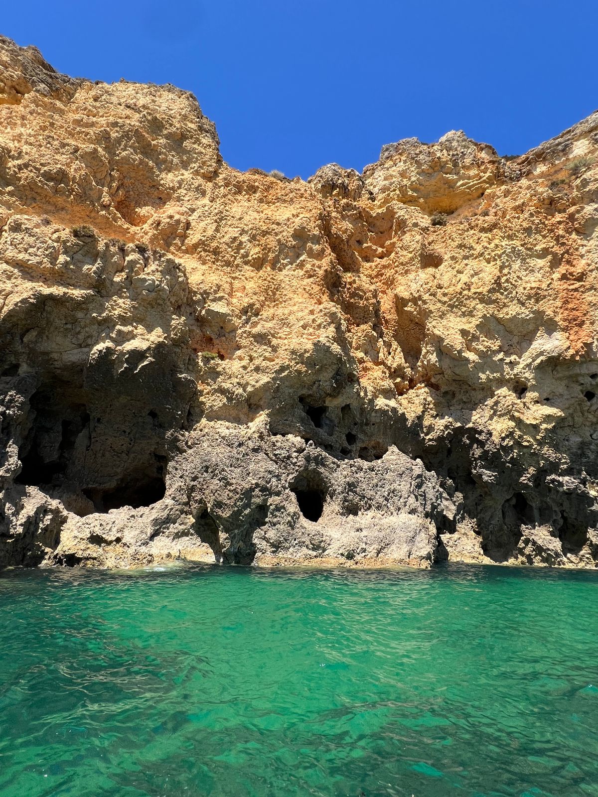 Golden sandstone sea cliffs and turquoise water on the central Algarve coast