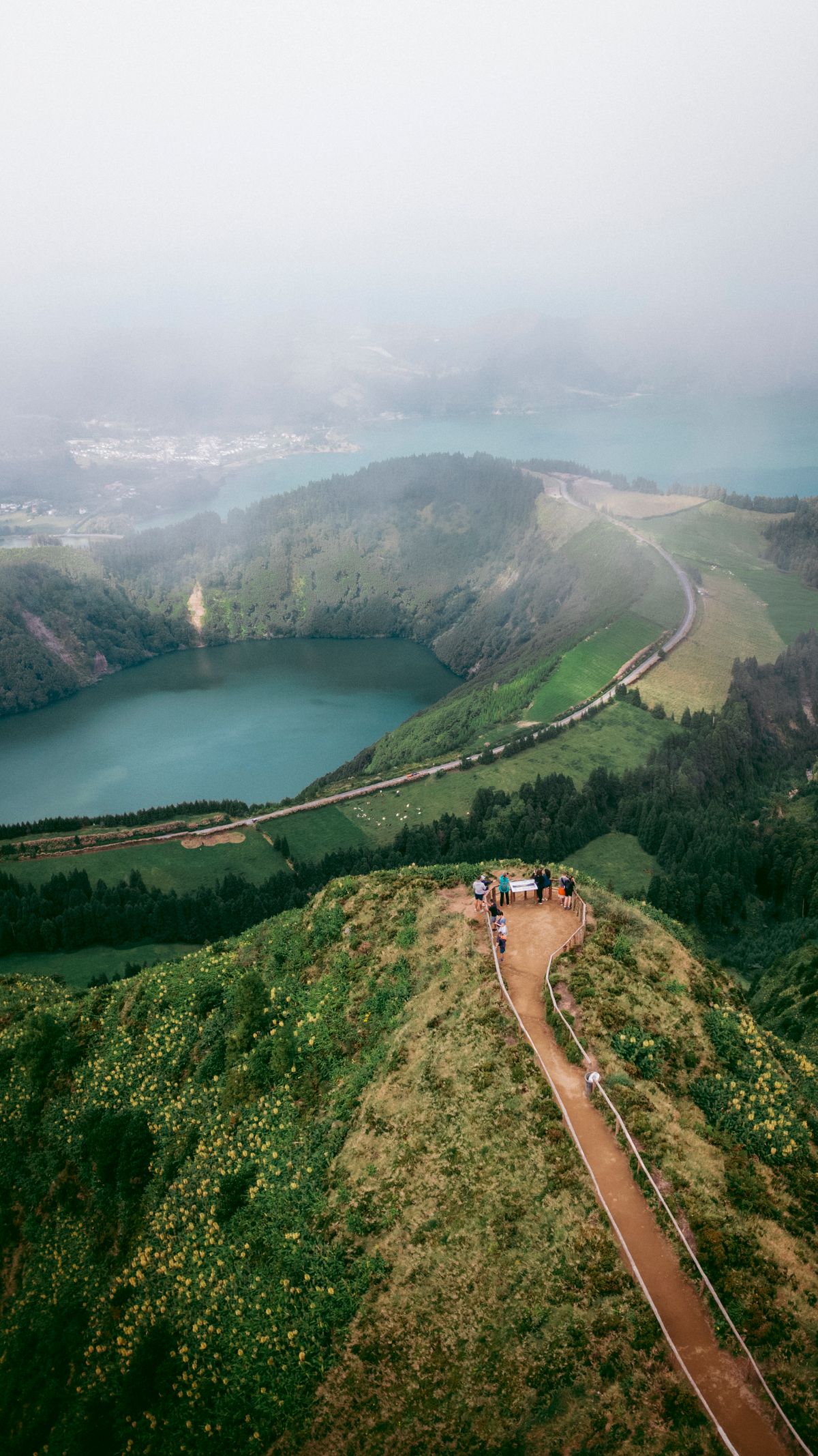 The blue and green twin crater lakes of Sete Cidades seen from the rim on São Miguel, Azores