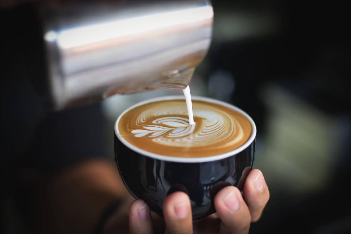 Woman holding espresso coffee cup specialty café Santiago Chile Barrio Italia roastery