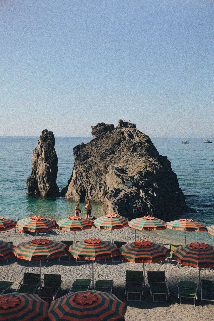 Sandy beach with striped umbrellas at Monterosso al Mare, Cinque Terre