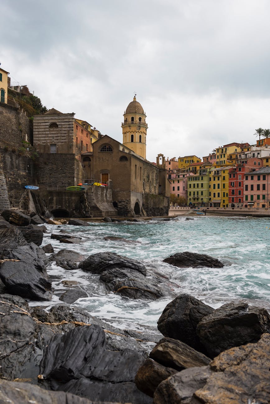 Scenic coastal view of Vernazza with colourful buildings and rocky shoreline in Liguria