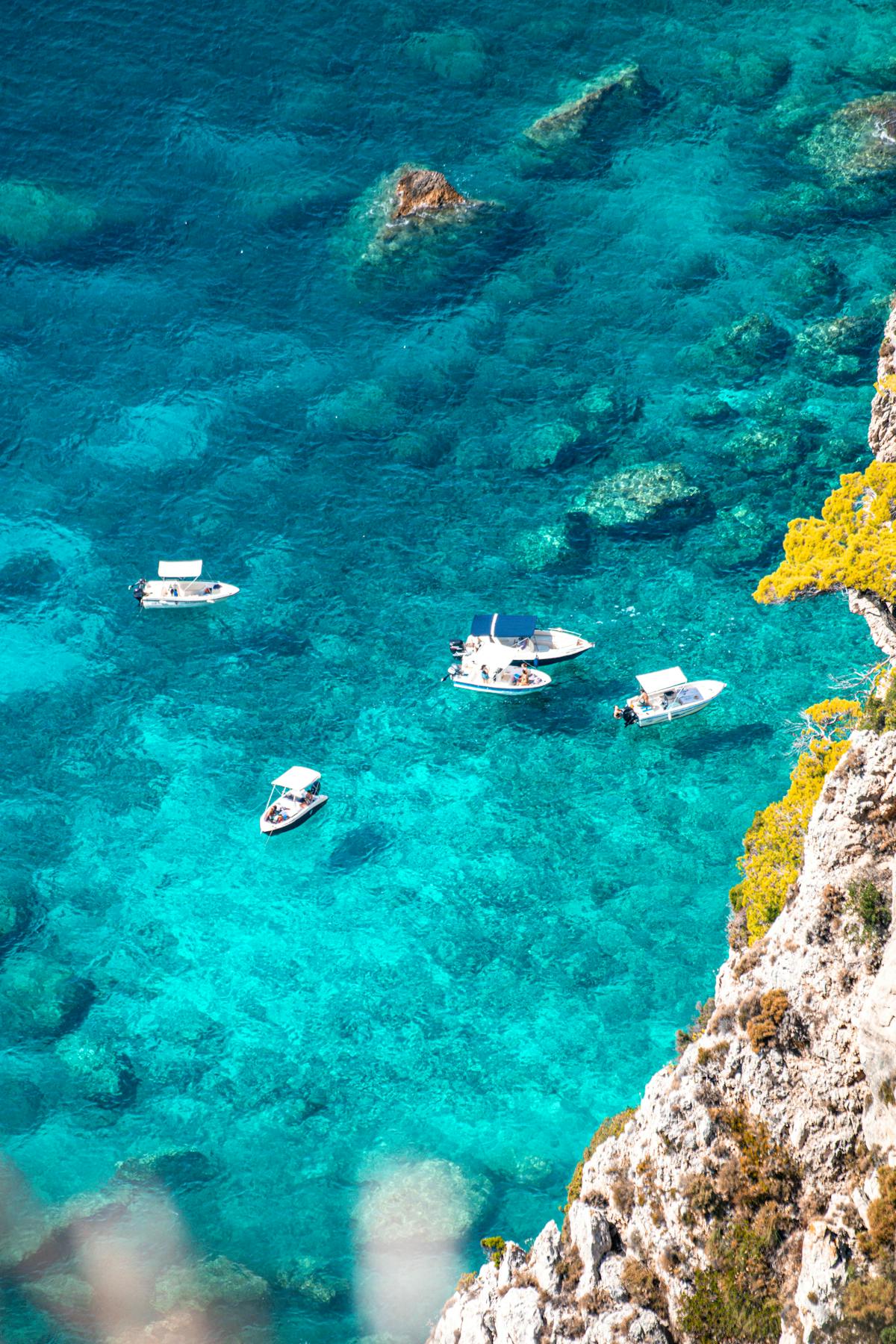 Boats on crystal-clear turquoise water at Paleokastritsa, Corfu
