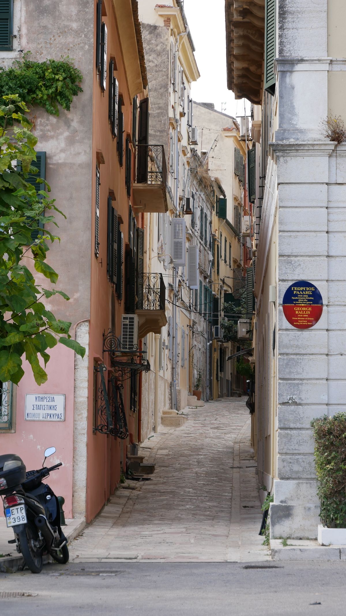 Picturesque narrow alley in Corfu old town with colourful buildings