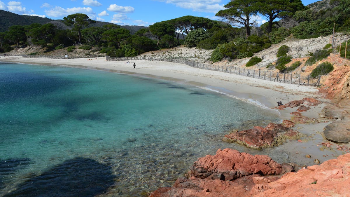 Turquoise water and pink granite rocks at a beach near Porto-Vecchio in southern Corsica