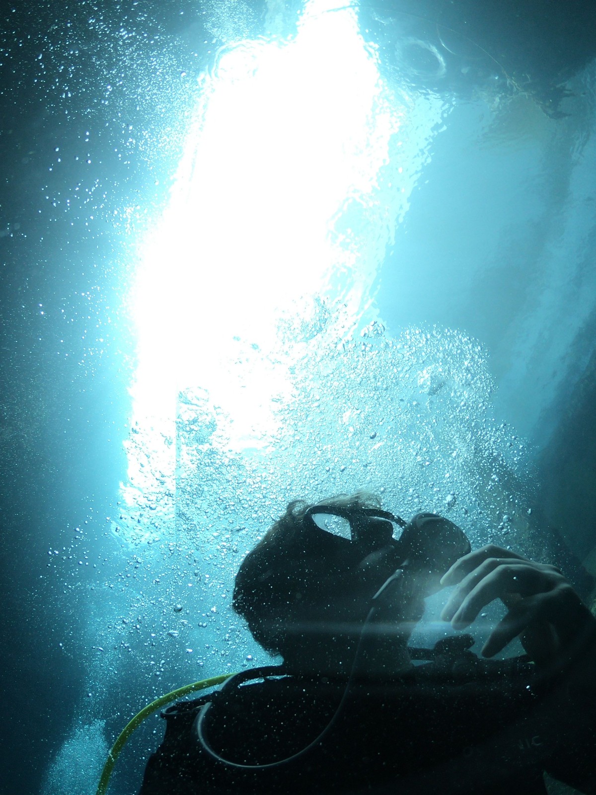 A snorkeller floating in the crystal-clear blue water of the Silfra fissure between tectonic plates in Iceland