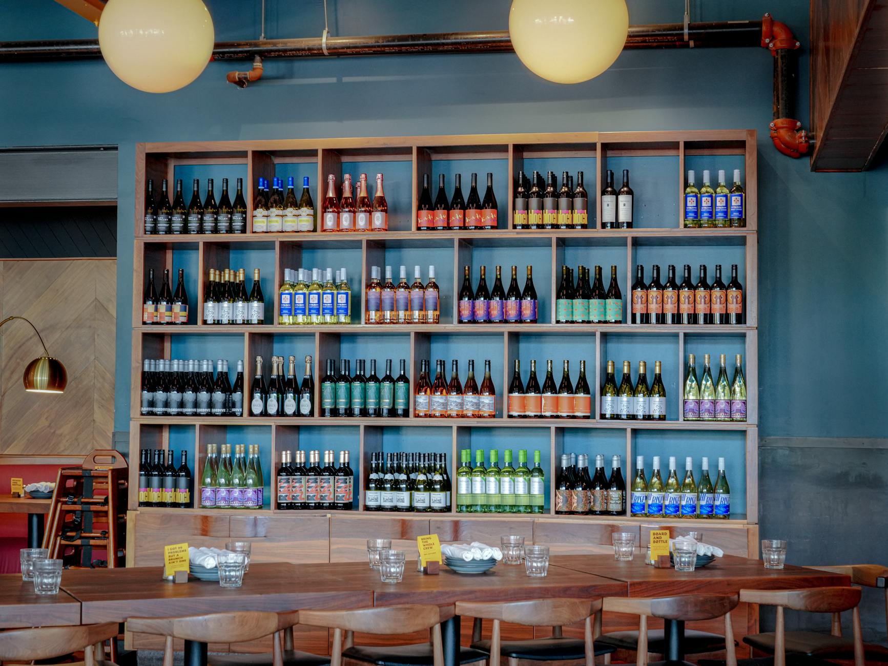 Natural wine bottles on shelf wine bar minimalist interior