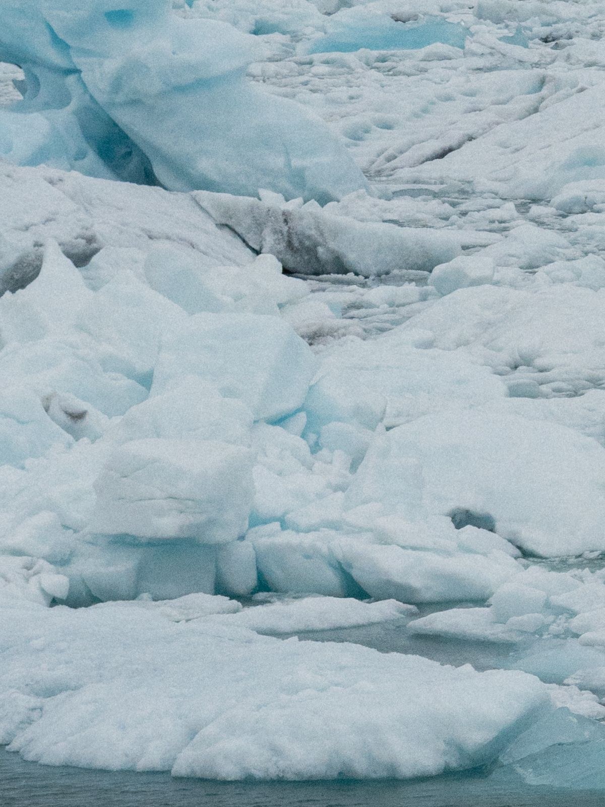 Icebergs floating in Jökulsárlón glacier lagoon with the glacier behind