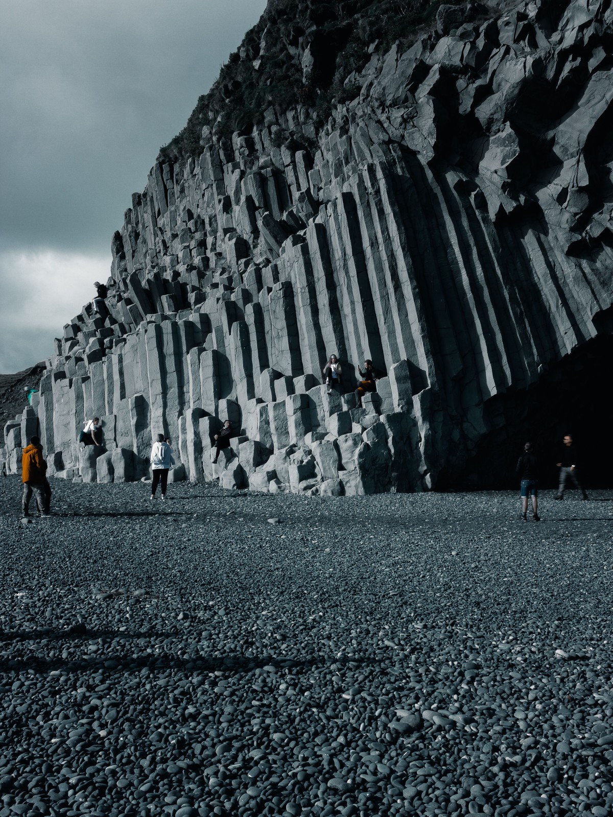 Black sand beach at Reynisfjara with hexagonal basalt columns and the Reynisdrangar sea stacks offshore