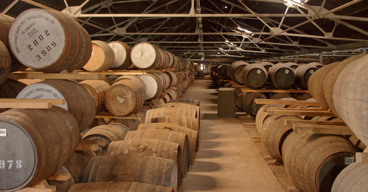 Rows of whisky barrels ageing in a distillery warehouse in Goa