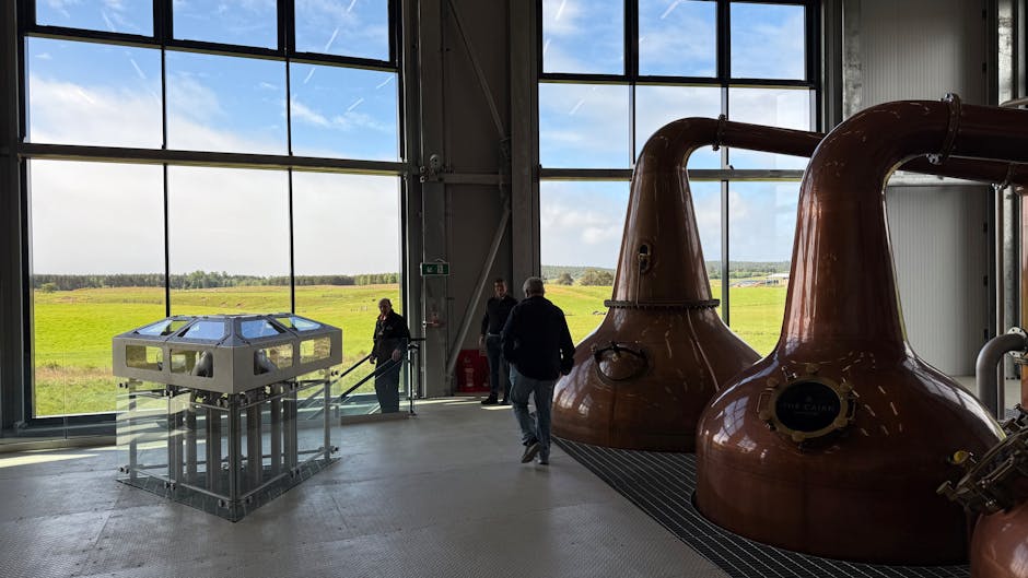 Copper stills and distillery equipment in a spirits production room