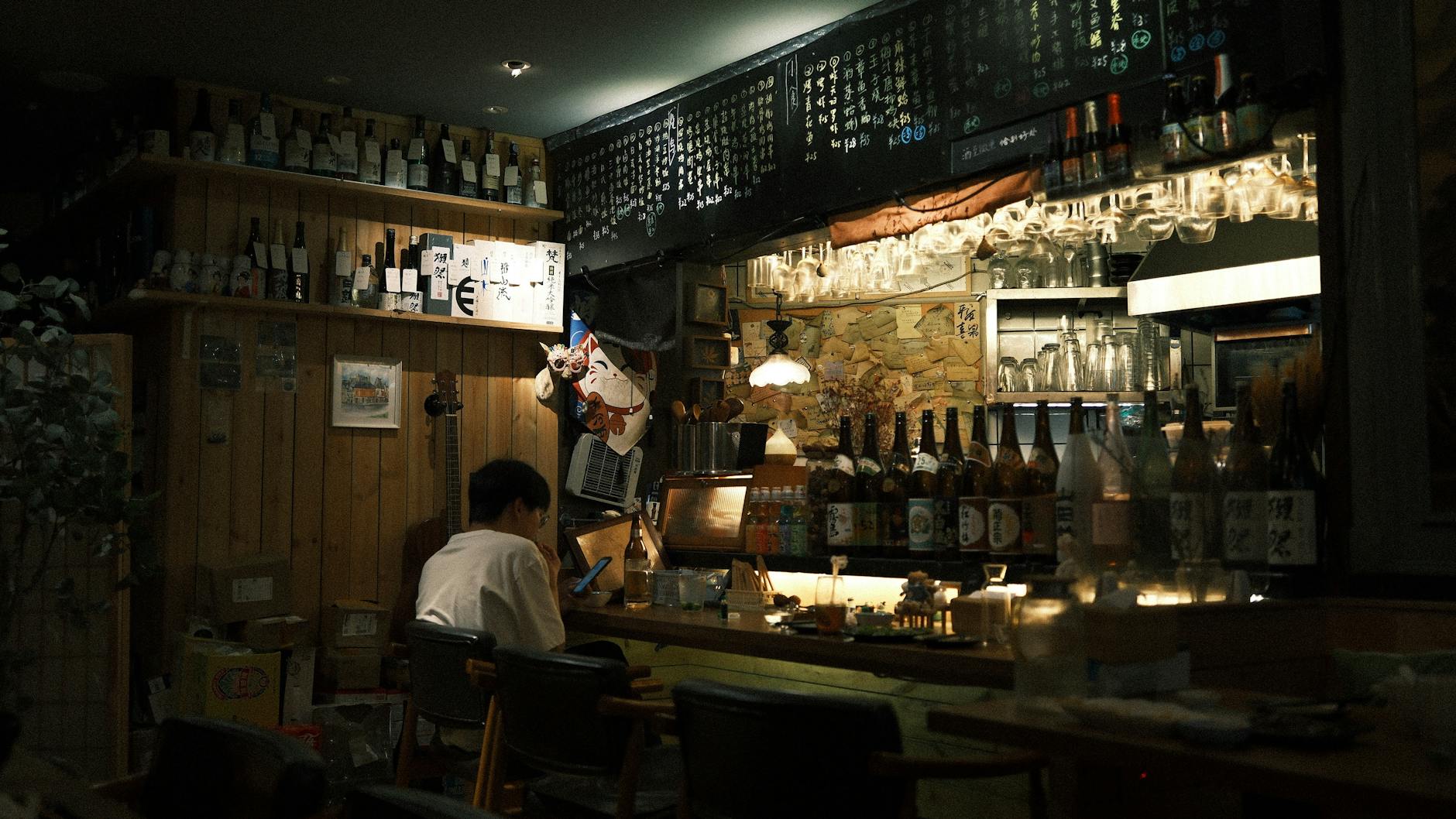 Kyoto izakaya sake bar counter traditional Japanese wooden interior night drinks