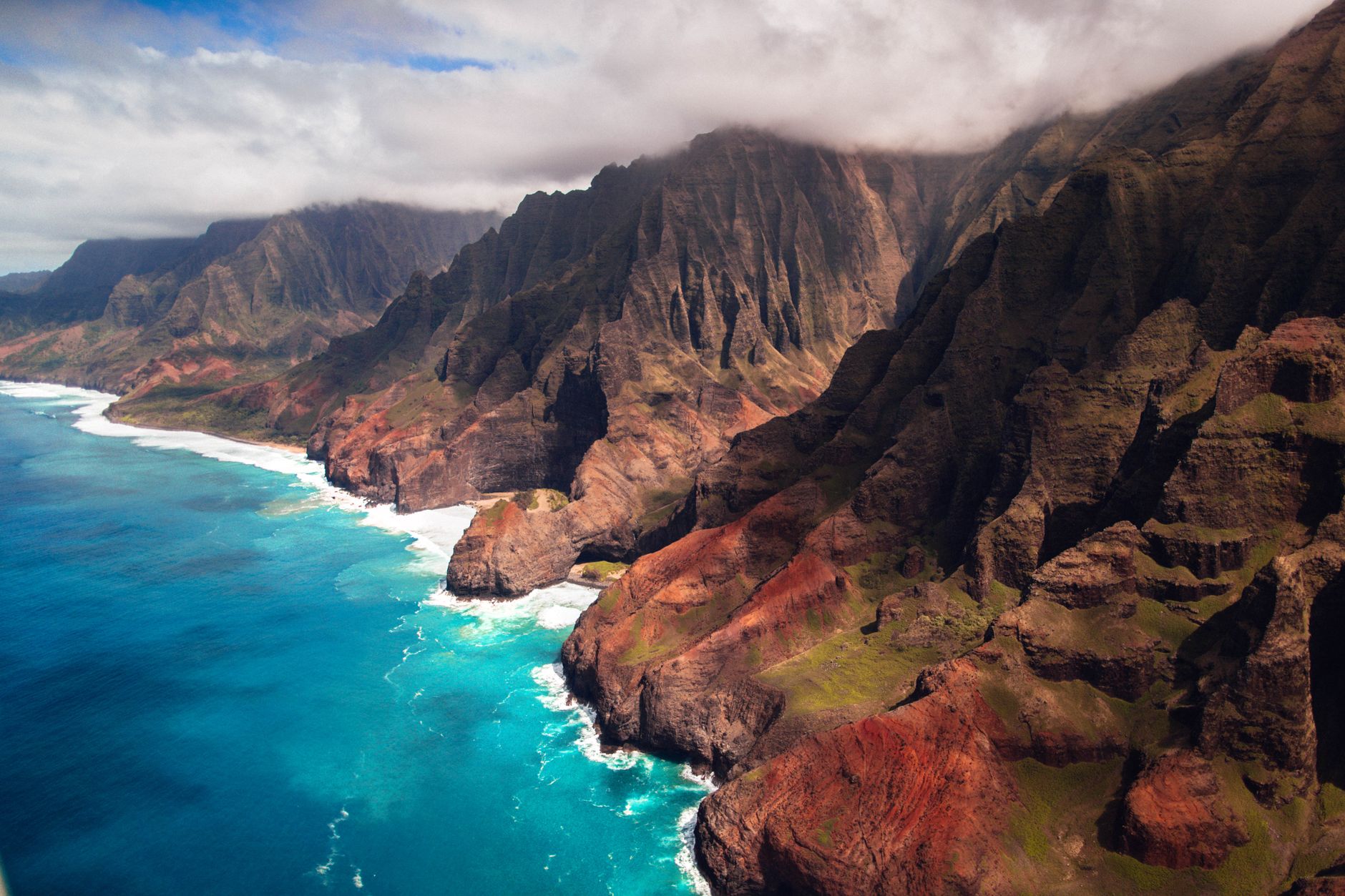 The fluted green cliffs of the Nā Pali Coast dropping straight into the Pacific on Kauai's north-west shore