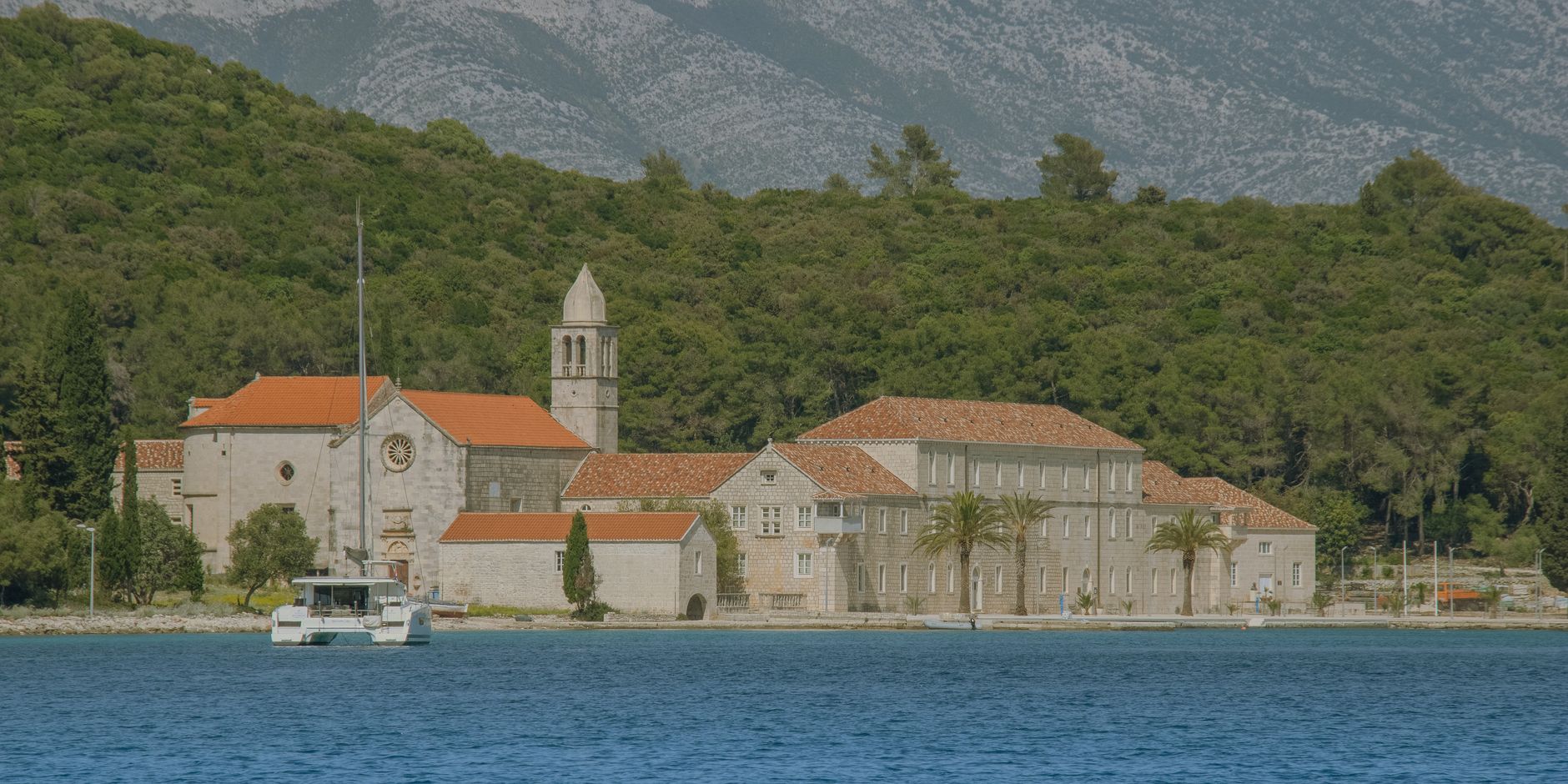 Franciscan monastery by the sea on Korčula Island with clear Adriatic water