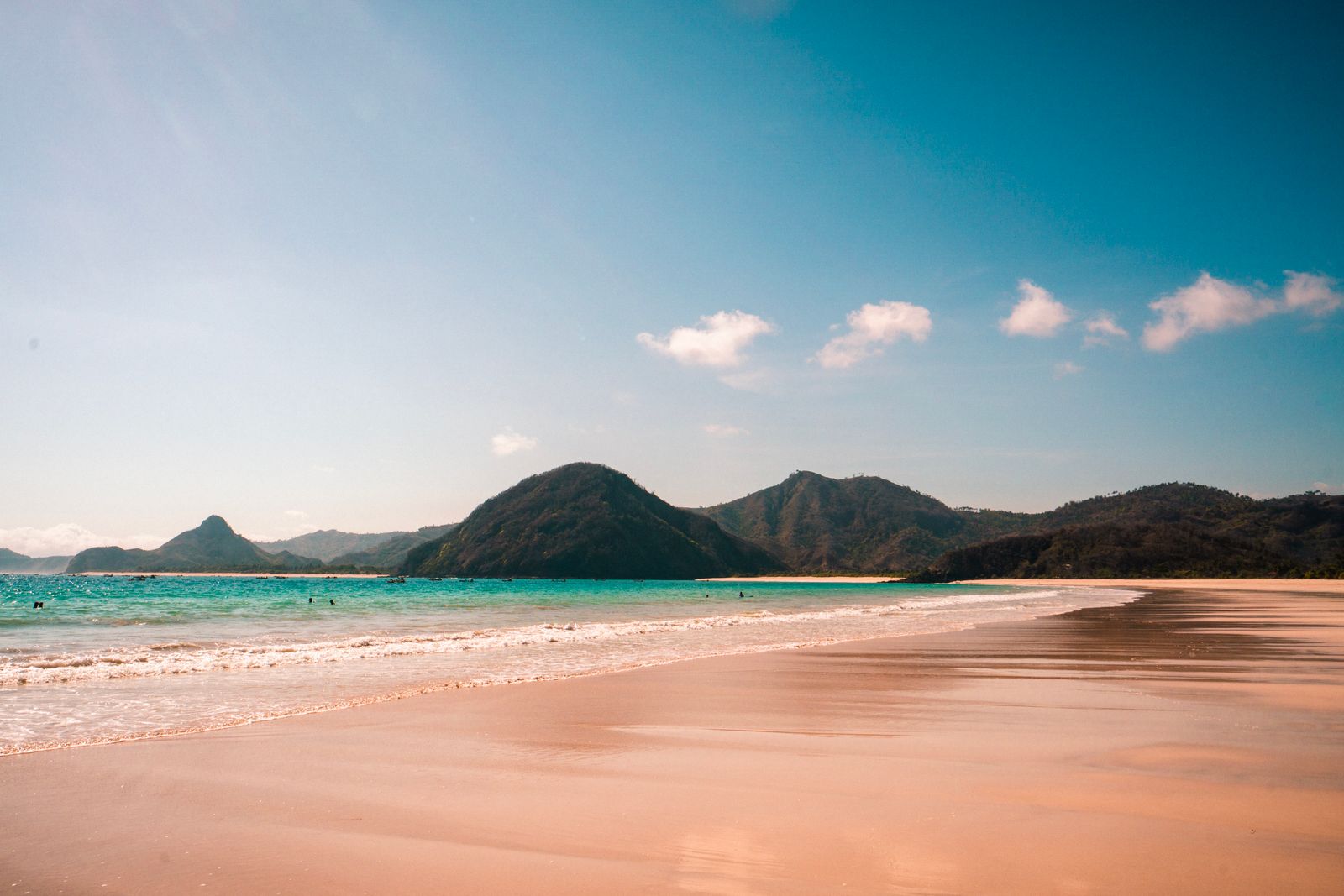 White-sand bay backed by green pyramid-shaped hills on Lombok's south coast