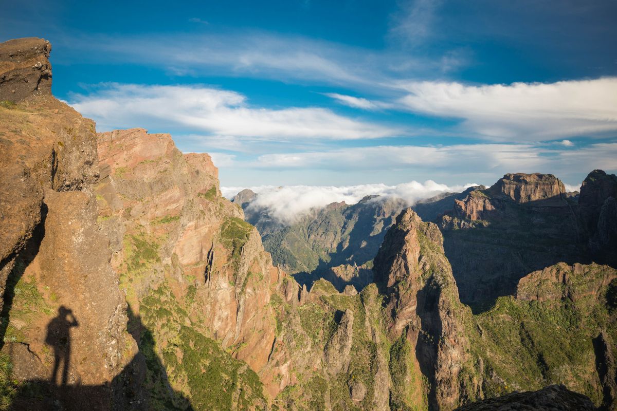 Sunrise over the Pico do Arieiro ridge with cloud-filled valleys below in Madeira