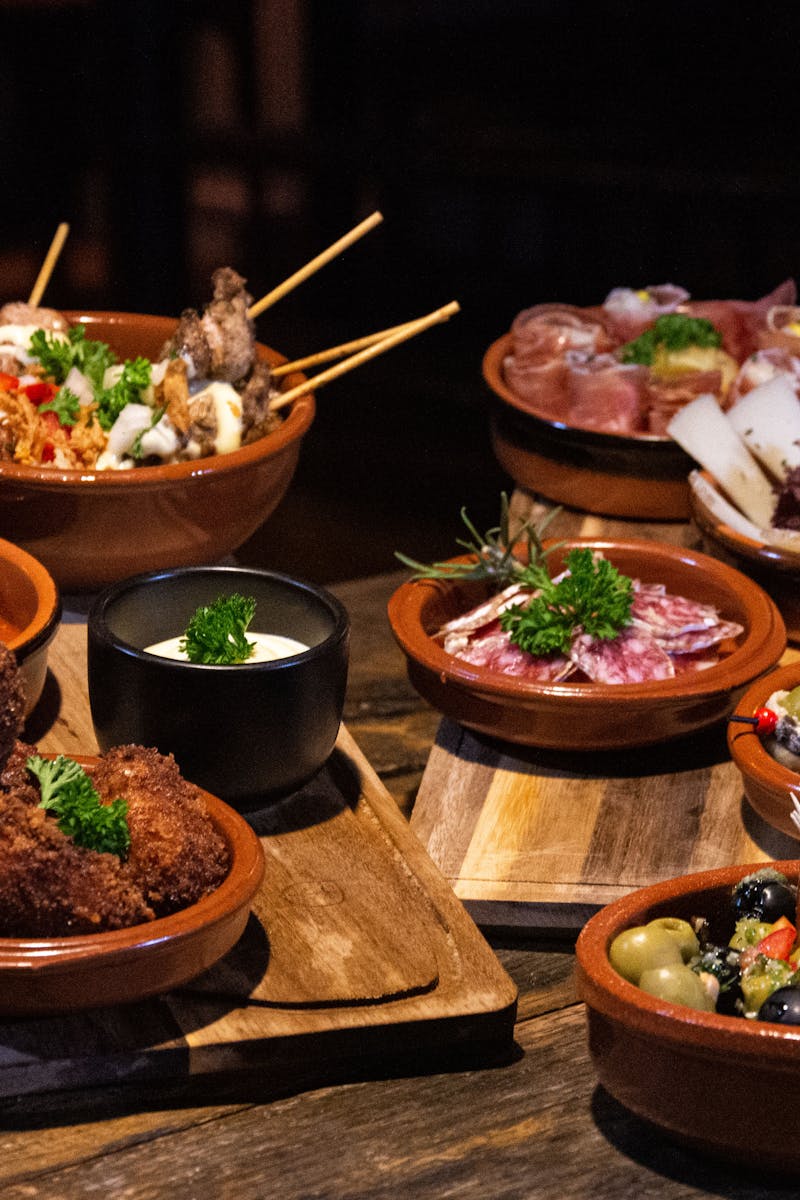 Assorted Spanish tapas dishes on a rustic wooden table