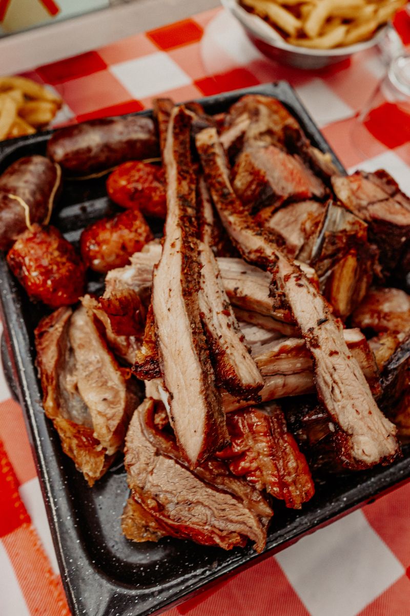 Argentine asado with grilled meats and chimichurri on a wooden board