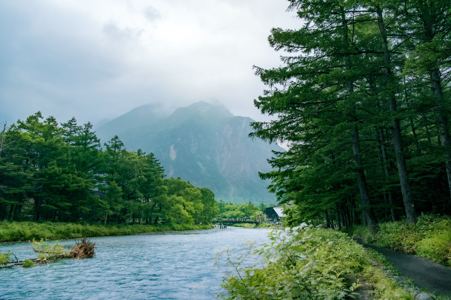 Kappa Bridge over the blue Azusa River with the Hotaka peaks rising behind in Kamikōchi