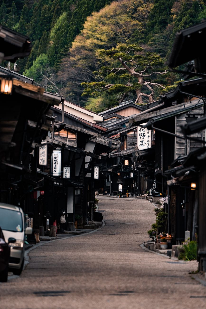 The dark wooden lattice houses and stone street of Tsumago post town with no power lines