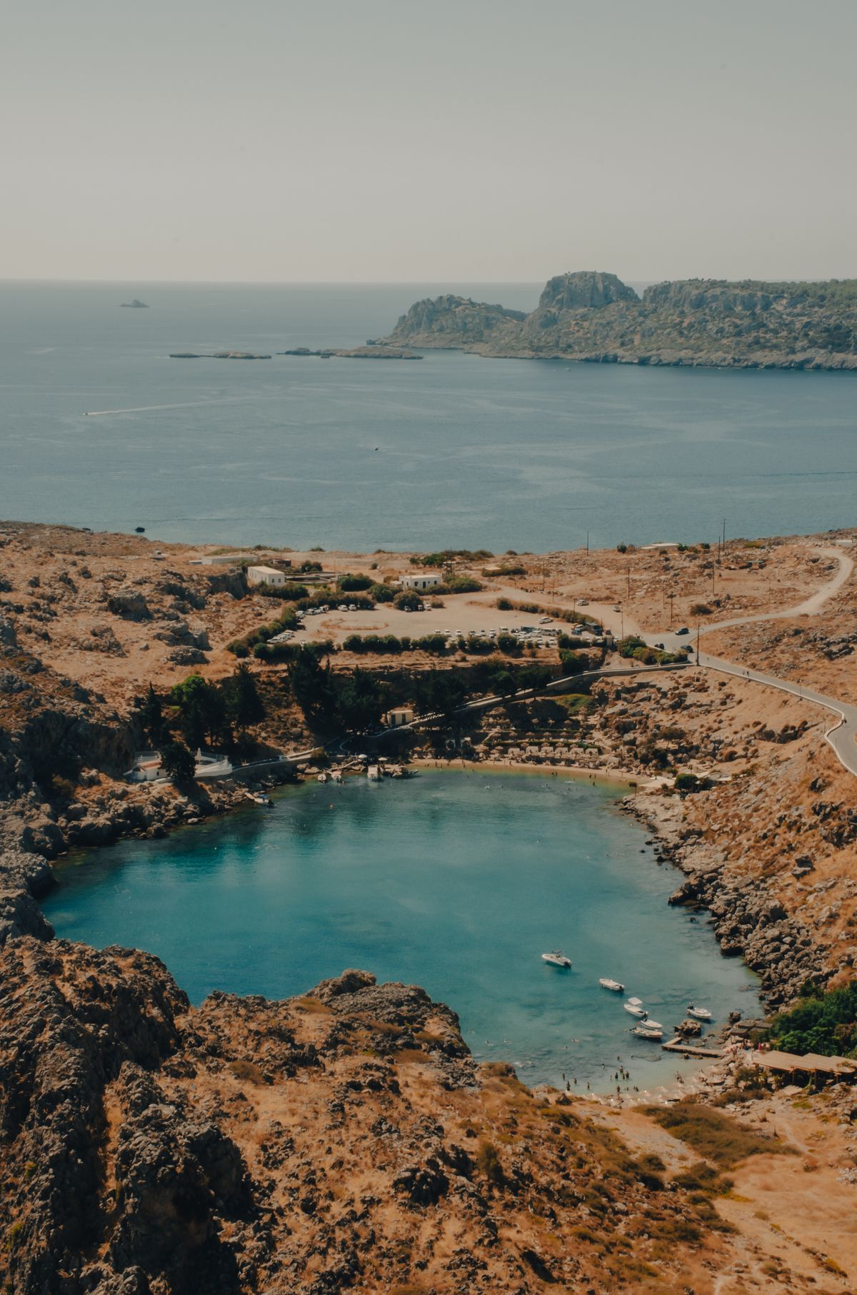 St Paul's Bay with clear turquoise water below the Lindos acropolis, Rhodes