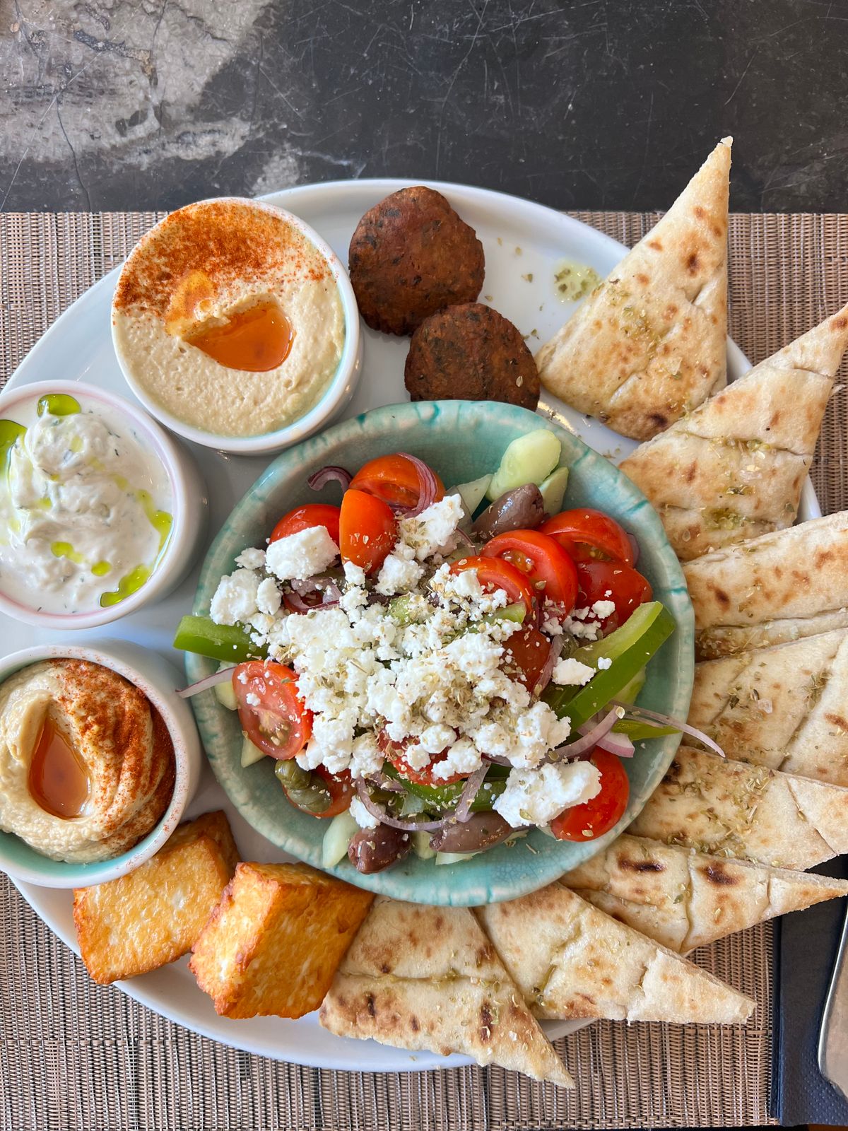 Authentic Greek meze platter with fresh ingredients on a wooden table