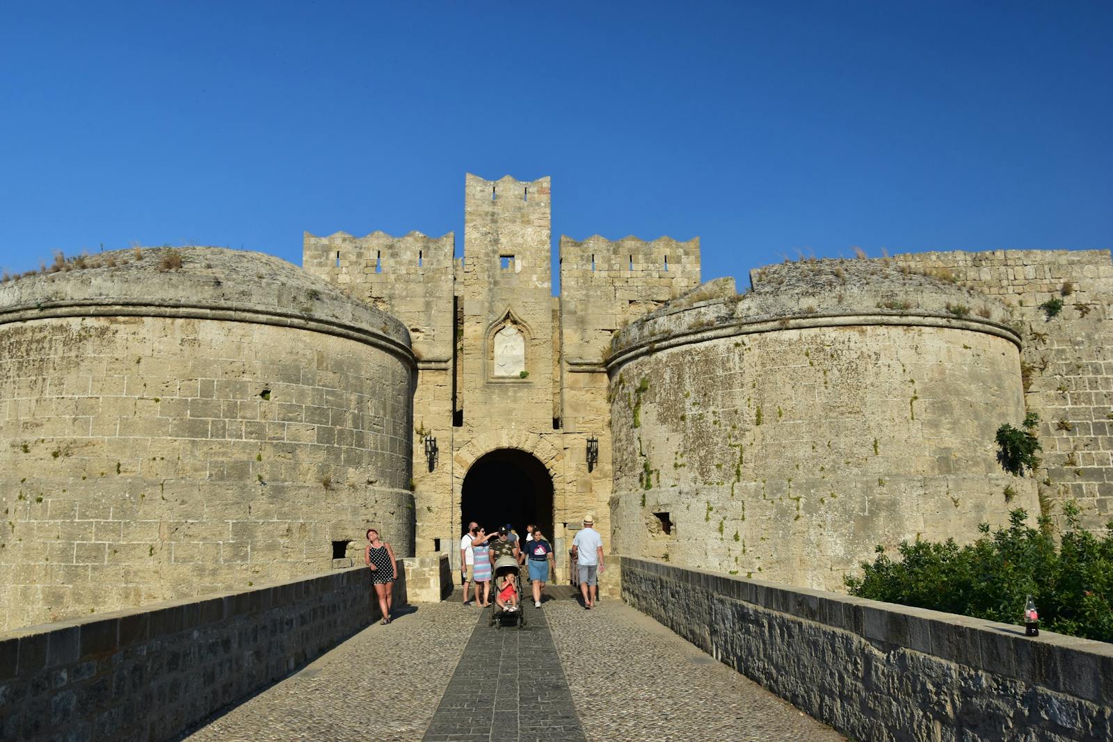 Historic fortress entrance gate in Rhodes Old Town under clear skies