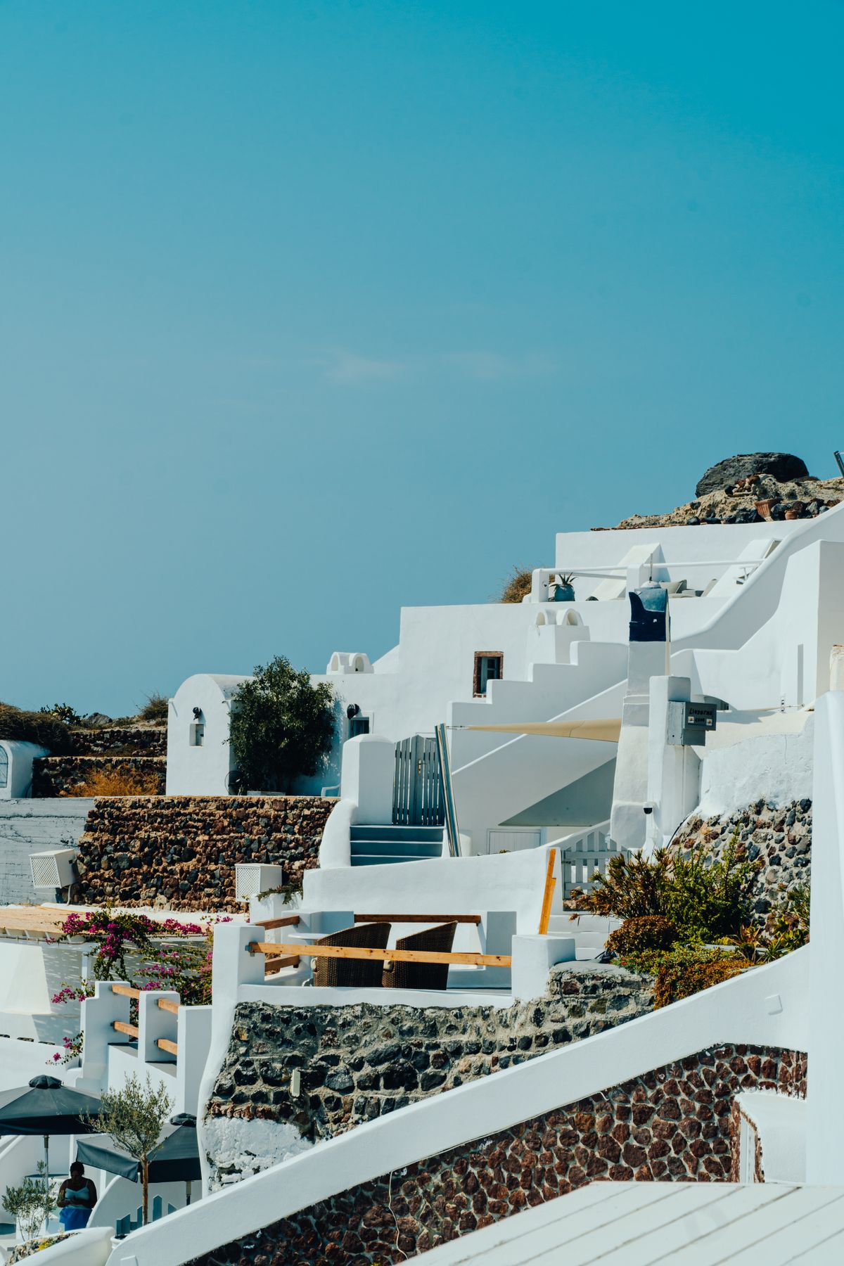 Whitewashed buildings and blue sky above Santorini's caldera rim