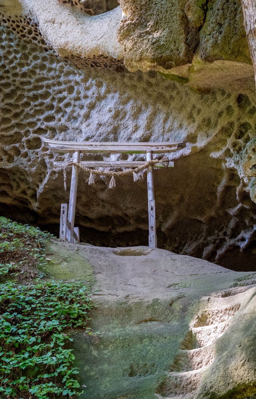 Narrow stone alley between traditional houses on a steep hillside on Ogijima, Seto Inland Sea