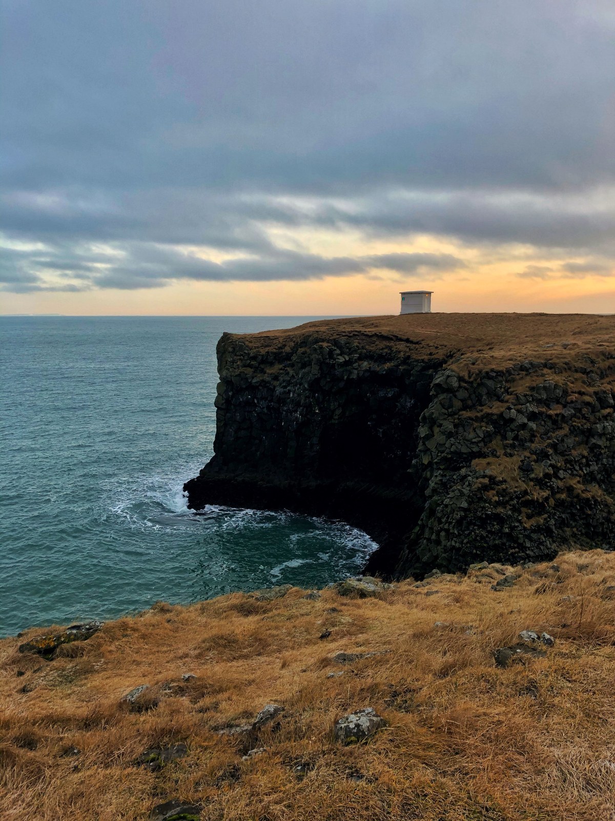 Basalt sea cliffs and a natural stone arch on the Arnarstapi coast, Snæfellsnes
