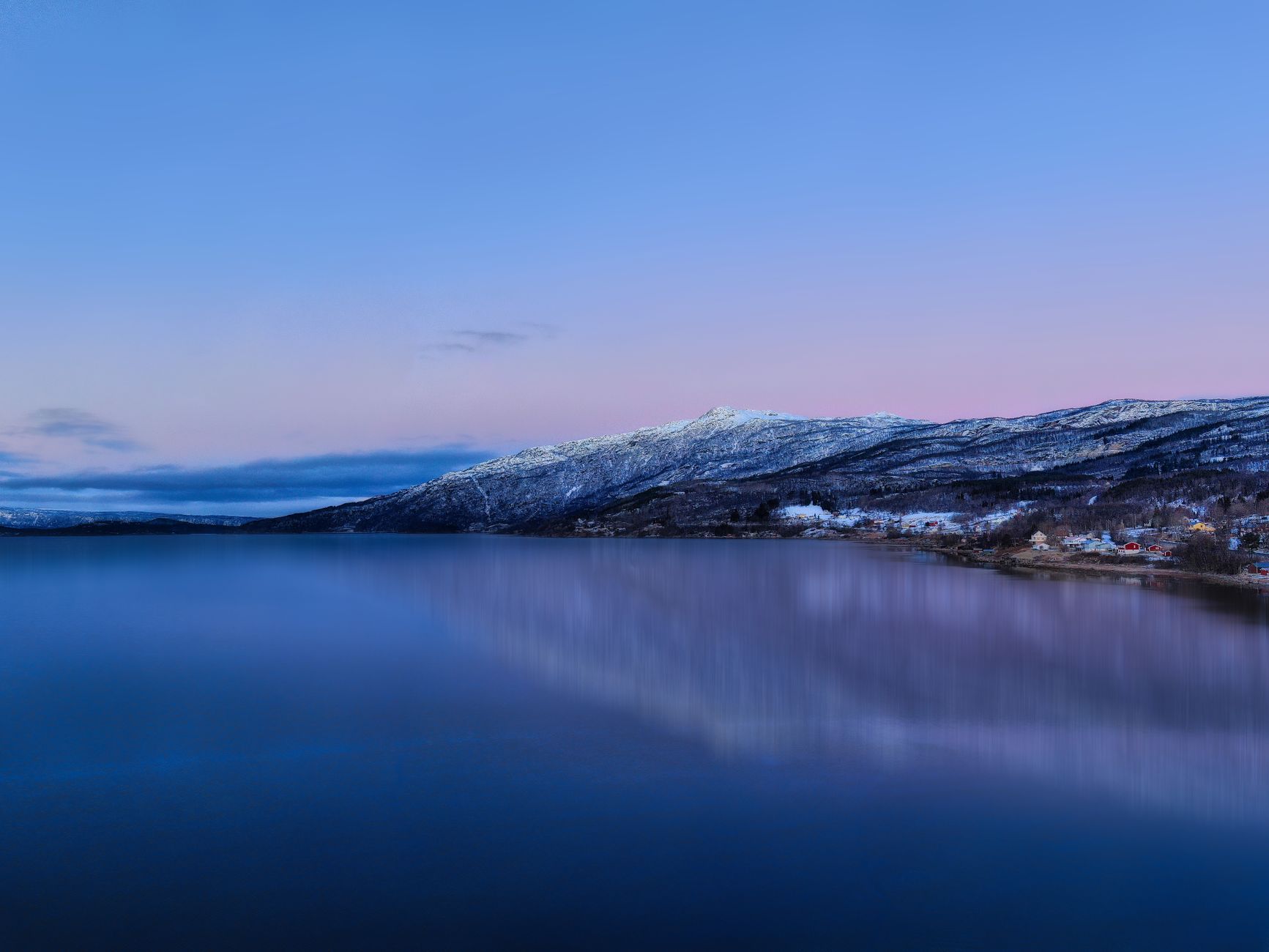 Green northern lights over snow-covered fells and the Lapporten valley in Swedish Lapland