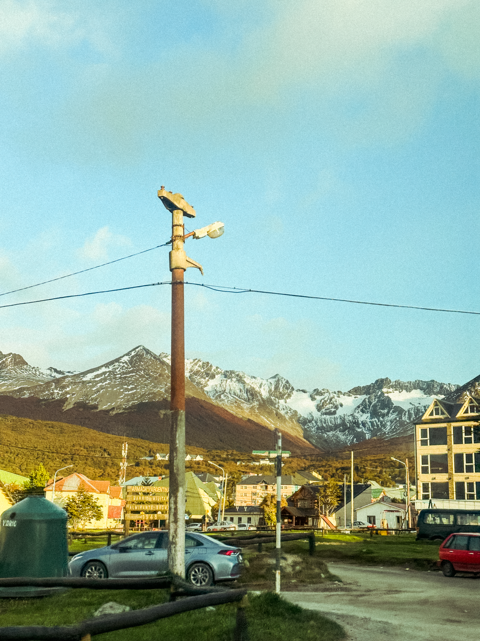 Ushuaia waterfront and colourful buildings below snow-streaked mountains