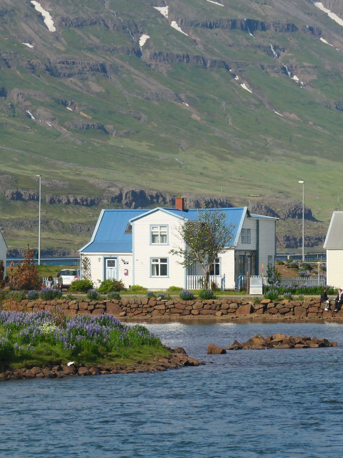 Colourful timber houses and harbour of Ísafjörður beneath snow-streaked mountains