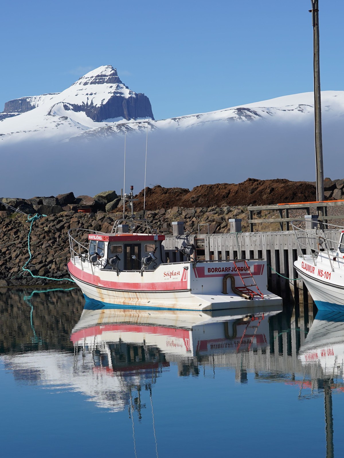 A small fishing harbour in a Westfjords village ringed by mountains