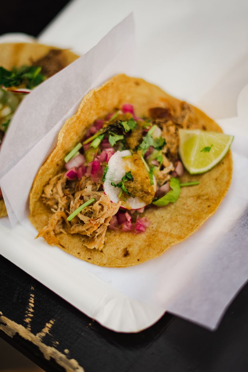 Cochinita pibil tacos with pickled red onion and habanero on a wooden table