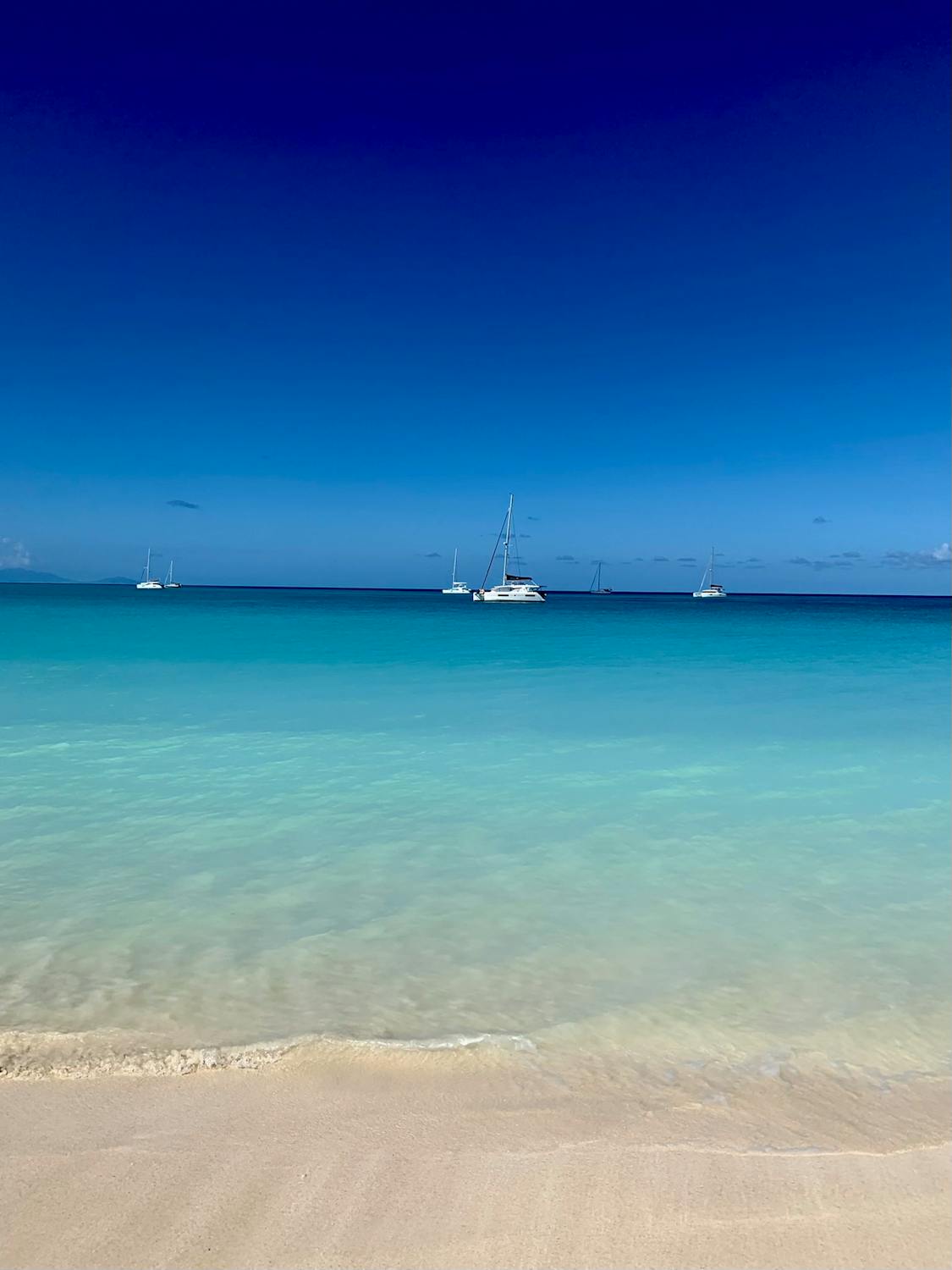 Luxury yachts anchored in Antigua's crystal-clear Caribbean waters